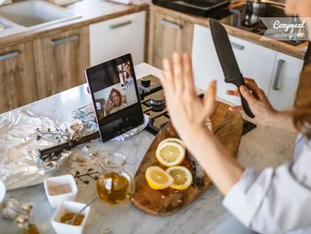model cooking with tablet in front of them 