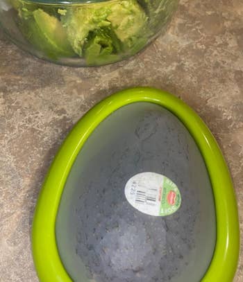 a reviewer photo of an avocado in the saver container 