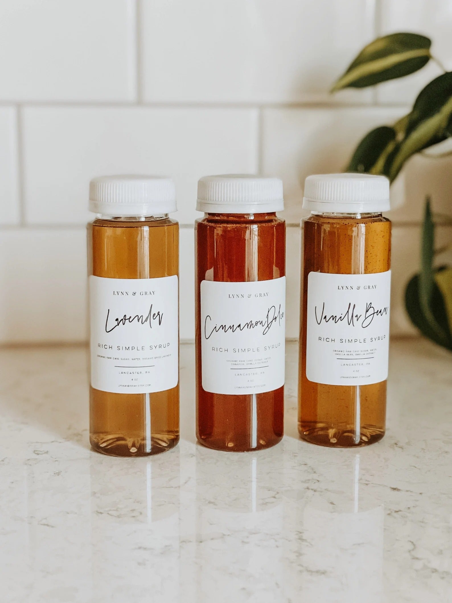 three flavored simple syrups on a kitchen counter