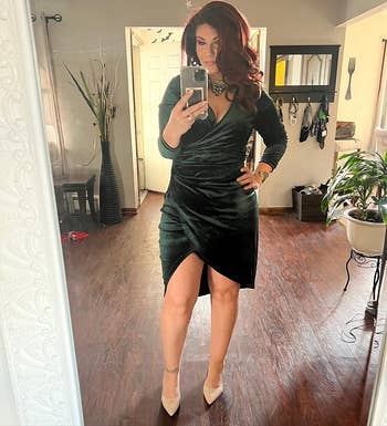 Reviewer pic of the velvet ruched mini dress in a dark green color