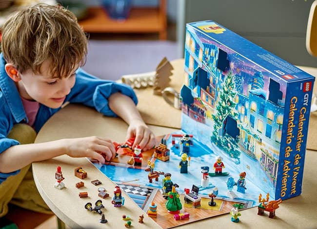 a child playing with a lego city advent calendar