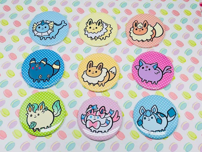 nine buttons each of a different eeveelution on a polka dot background