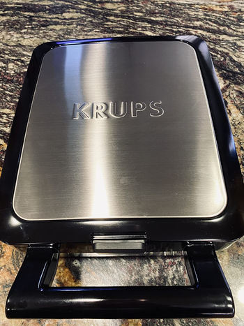 Reviewer image of the black and silver waffle maker