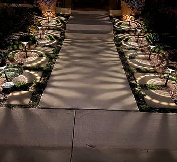 a reviewer photo of the lights lining a walkway casting white light 