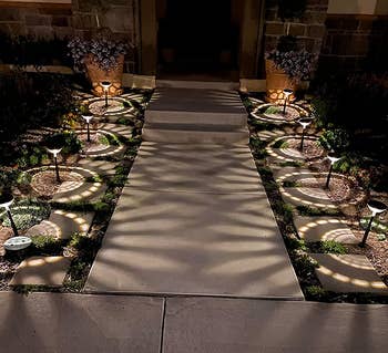 a reviewer photo of the lights lining a walkway casting white light 