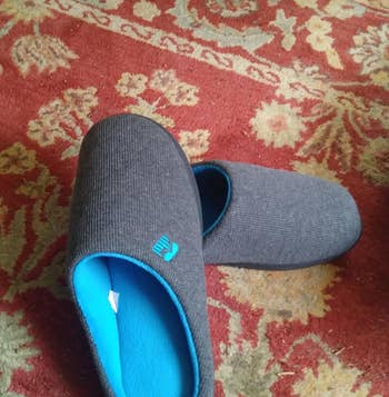 reviewer photo of the slippers showing the blue memory foam sole