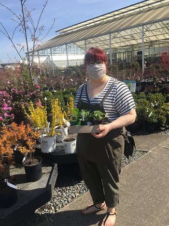 reviewer wearing the overalls successful  green