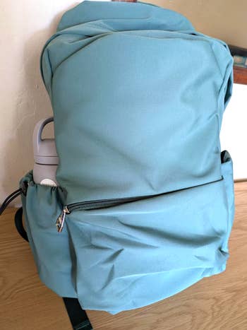 A spacious backpack with a beforehand   zipper pouch  and broadside  h2o  vessel  holder, perfect  for schoolhouse  oregon  question   use