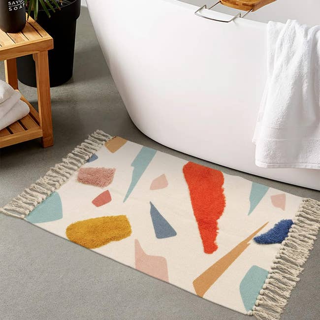 image of the long tassel rug with different colored shapes and colors