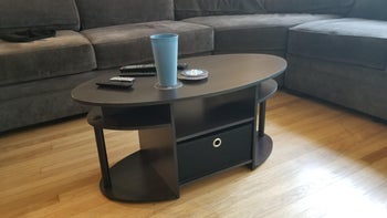 reviewer photo of black oval coffee table in living room