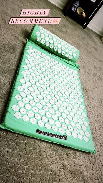 reviewer pic of same acupressure mat and pillow in a light green color