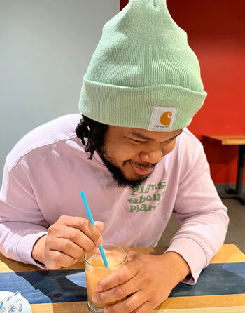 reviewer wearing the beanie in green