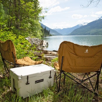 two yellow mammoth camping chairs by a lake
