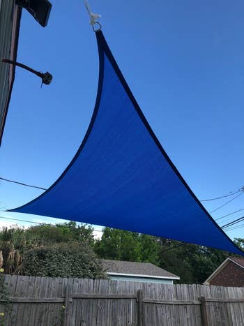 reviewer image of a blue sail canopy over backyard