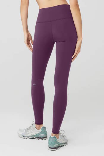 Model in a pair of purple leggings 