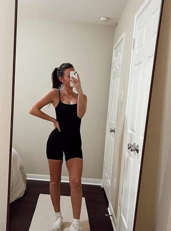 a reviewer wearing the black romper