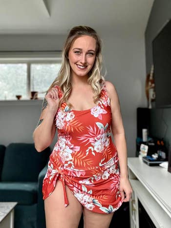 reviewer wearing the swimdress in orange and white floral
