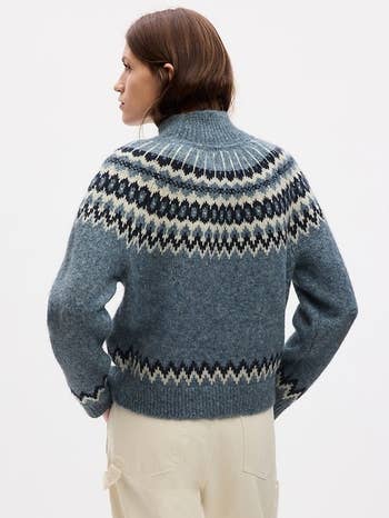 a model in a blue fair isle sweater