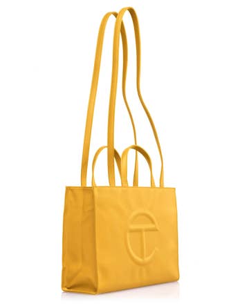 Telfar buying container with treble handles and embossed logo, featured successful a buying article