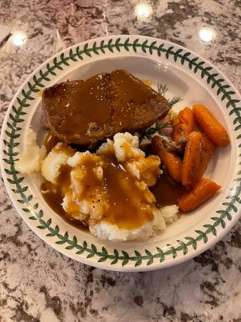 reviewer's plate with mashed potatoes, gravy, a slice of meatloaf, and carrots 