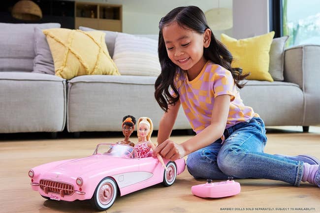 a pink remote controlled barbie corvette car