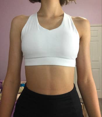Reviewer in white scoop neck sports bra 
