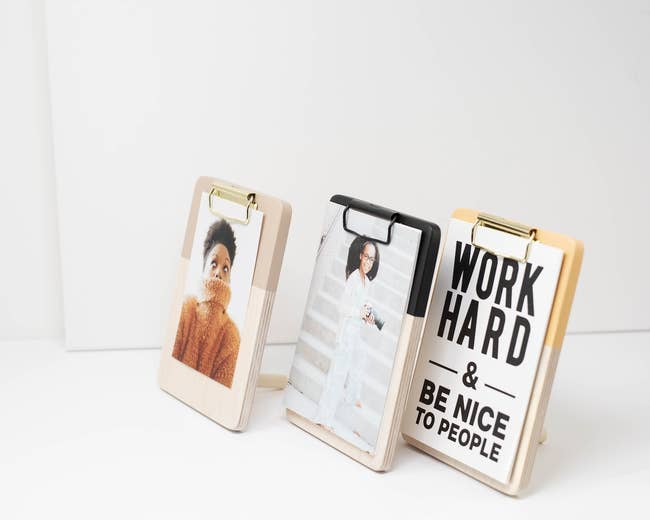 Three clipboards with inspirational quote and photos on display