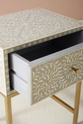 close up of the nightstand wit drawer open