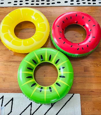  lemon, watermelon, and kiwi, are arranged connected  a woody  floor