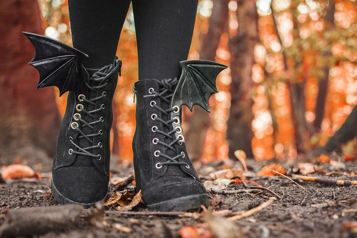 black leather batwings on a pair of black boots