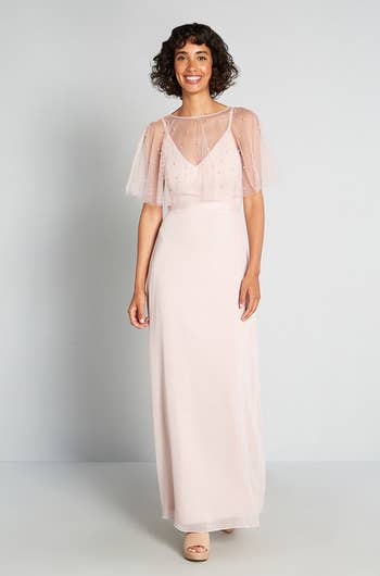 model posing in the long blush pink gown