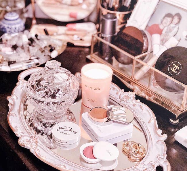 the tray with various makeup on it on the reviewers dresser
