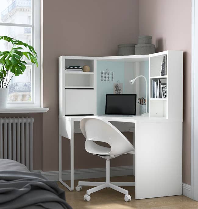 the white corner desk with a hutch and multiple cubbies