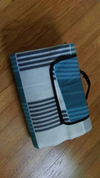 reviewer photo of rolled up blue picnic blanket