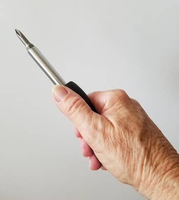 reviewer holding the compact screwdriver