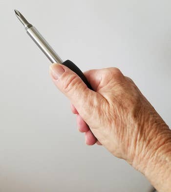 reviewer holding the compact screwdriver