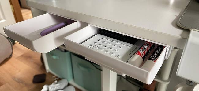 reviewer image of two white sliding under desk drawers mounted under a desk
