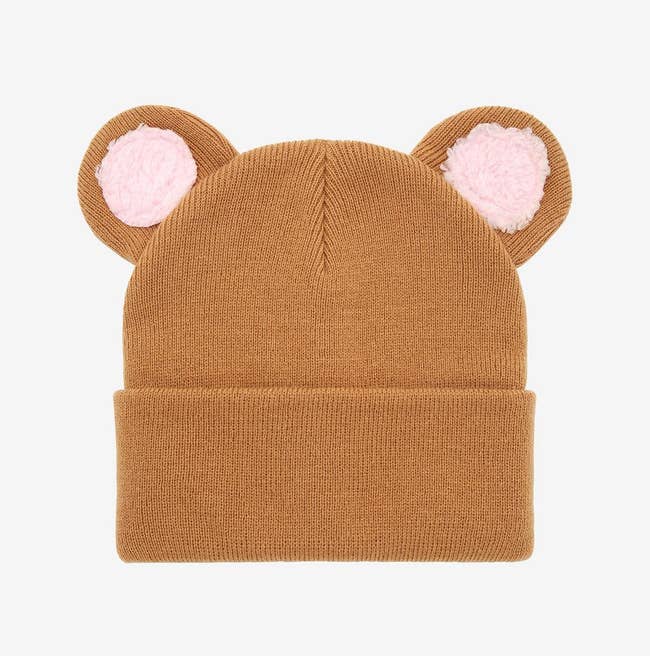 Brown beanie with brown and pink ears on top on a white background
