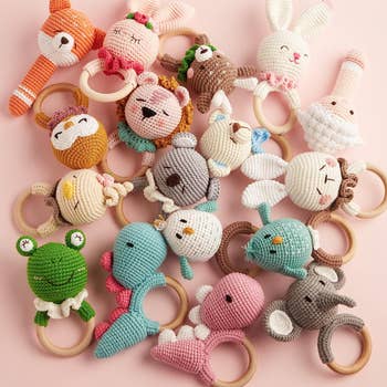 several rattles with wooden ring and crochet animal on top