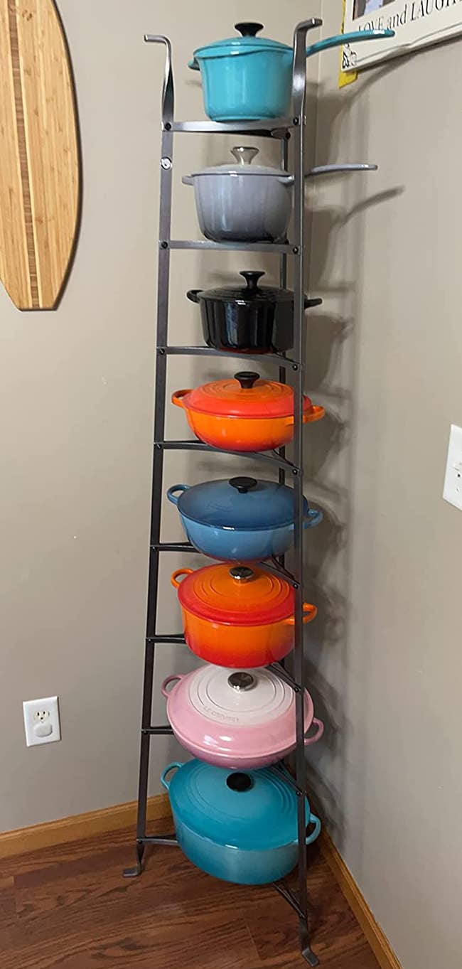 Reviewer image of pot and pan organizing tower against a corner wall with multicolored 