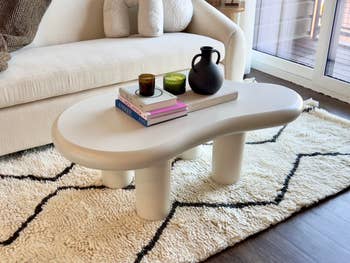 Modern coffee table with decor and books, in a cozy living room setting. Ideal for interior design inspiration