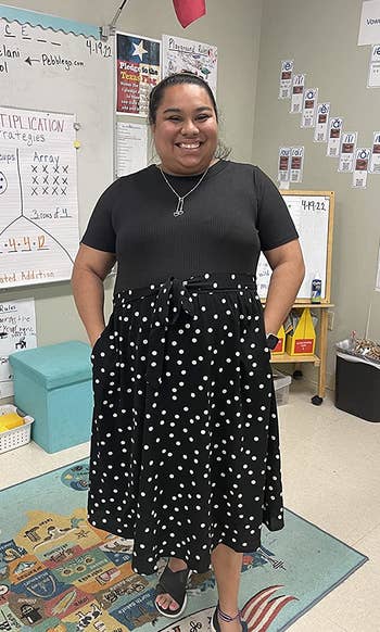 Reviewer wearing black polka dot dress