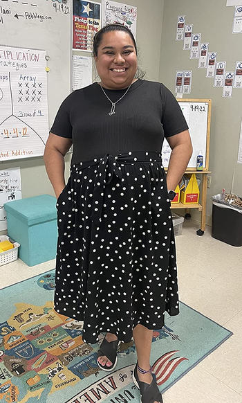 Reviewer wearing black polka dot dress