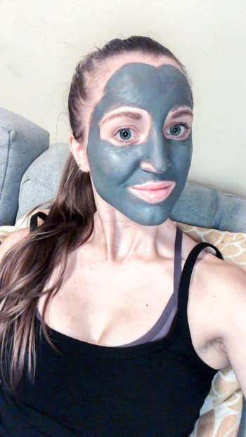 a reviewer wearing the grey mud mask