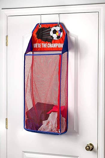 The soccer-themed hamper hanging on a door