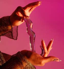 Model holding glass dildo