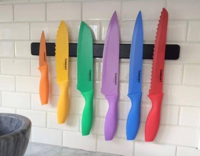 a reviewer's set of the knives, each of which is a different color of the rainbow 