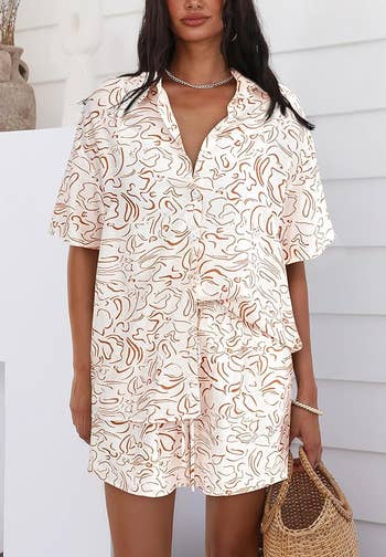model in an ivory and beige patterned short-sleeve top and shorts set 