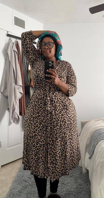 Reviewer in a brown leopard robe taking a mirror pic