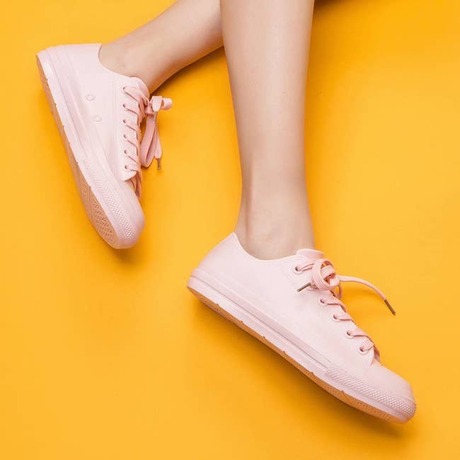 a model in pink water proof sneakers